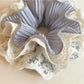 Side view of Gifty sweet ruffled scrunchie highlighting the elastic band and fabric layers