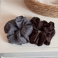 Close-up of Gifty solid color scrunchie showing smooth fabric texture