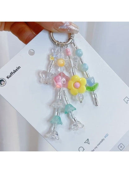 Keypus star and flower charm keychain displayed on a wooden surface