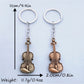 Side view of the vintage guitar keychain highlighting its slim profile and metal finish