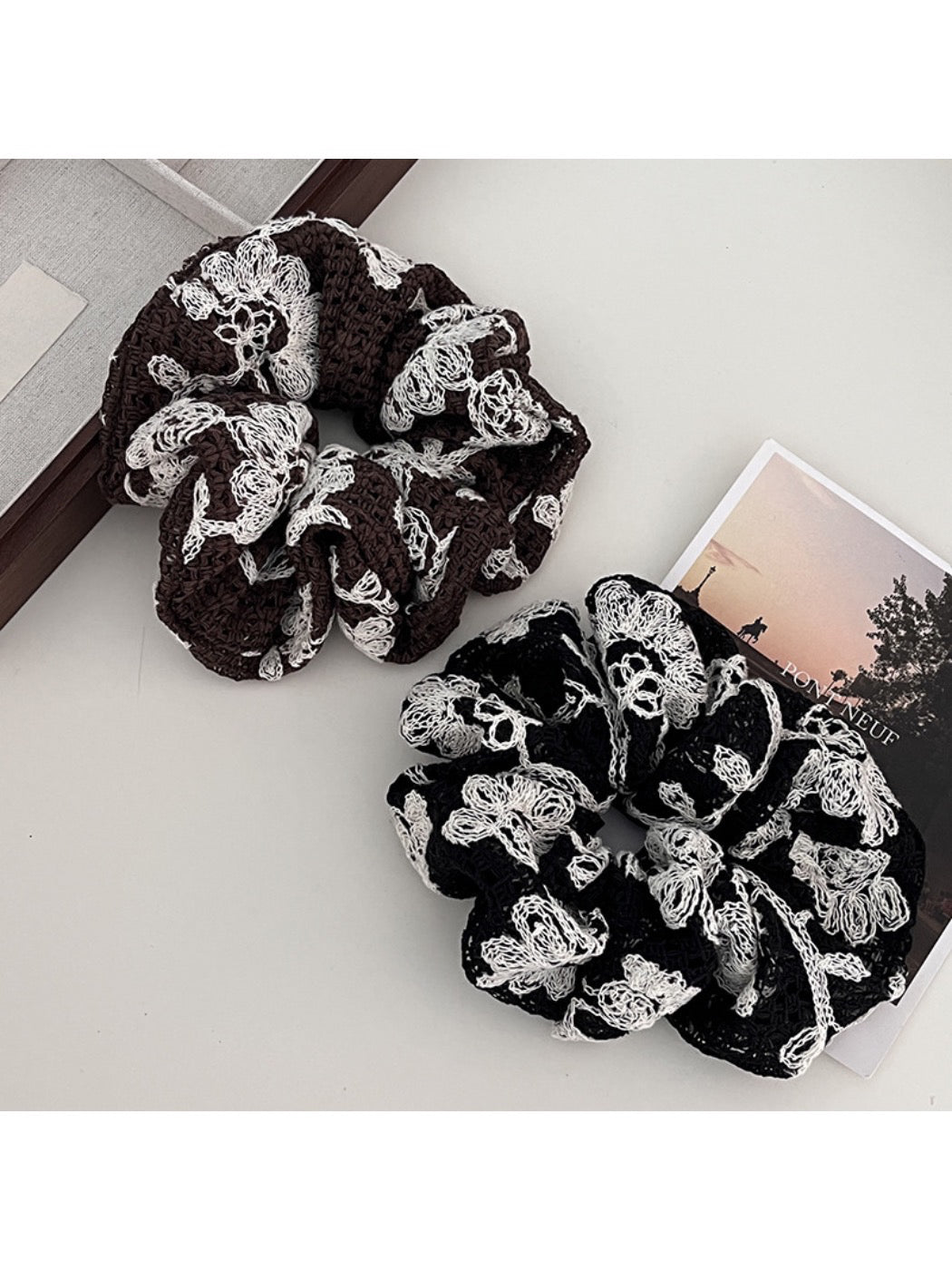 Close-up of Gifty artistic textured surface scrunchie in soft pastel colors