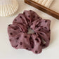 Set of polka dot ruffled scrunchie and headband displayed together