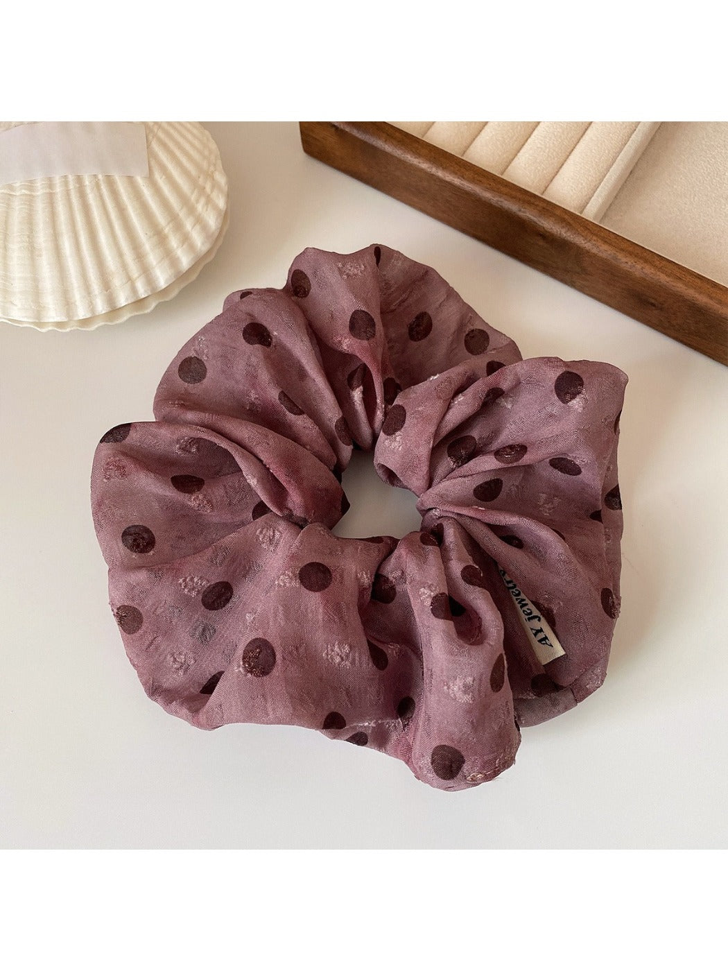 Set of polka dot ruffled scrunchie and headband displayed together