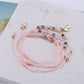 Lovra small bead bracelet with butterfly pendant shown in natural light