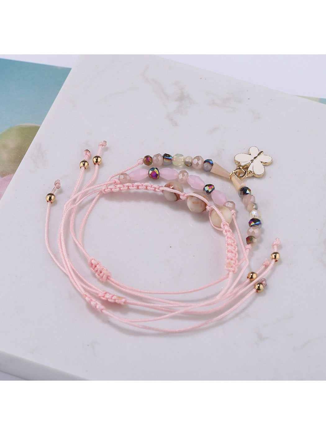 Lovra small bead bracelet with butterfly pendant shown in natural light