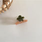 Beau flower hair clip styled with casual outfit on a model