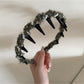 Gifty fluffy headband displayed flat with visible stitching and fabric