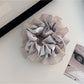 Gifty scrunchie displayed with matching hair accessories in coordinated colors