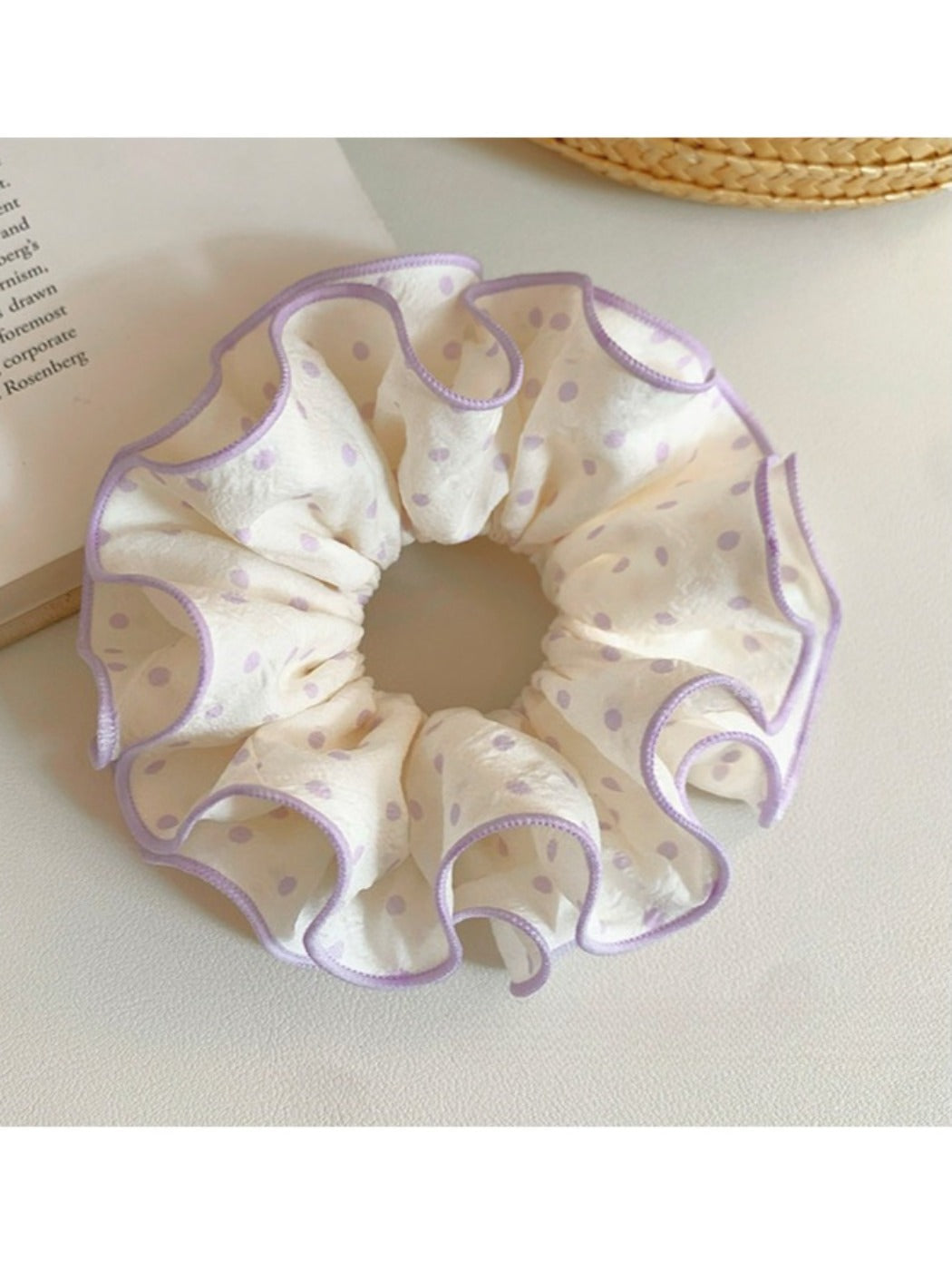 Sweet purple scrunchie with white polka dots on a white background