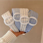 Close-up of Gifty plaid circular headband fabric texture and pattern