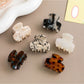 Close-up of Beau hair clip highlighting retro pattern and glossy finish