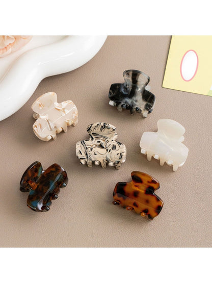 Close-up of Beau hair clip highlighting retro pattern and glossy finish