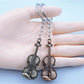 Close-up of the guitar keychain showing textured alloy surface and keyring attachment
