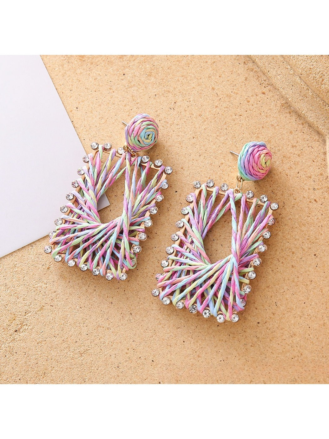 Side view of raffia square shape drop earrings showing texture and weave