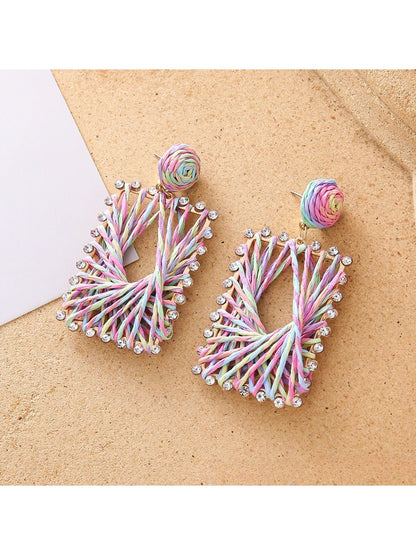 Side view of raffia square shape drop earrings showing texture and weave