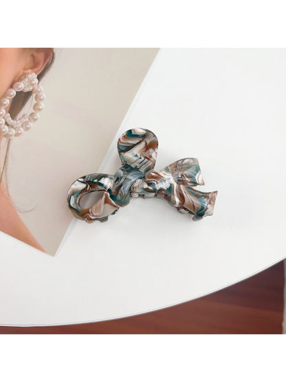Beau bow hair claw clip clipped into thick brown hair
