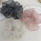 Close-up of Gifty elegant minimalist pleated scrunchie in soft beige fabric