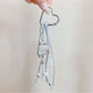 Keypus bag charm keychain attached to a handbag strap in natural lighting
