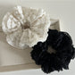 Gifty Sweet Cutout Lace Scrunchie worn on a wrist as a stylish accessory