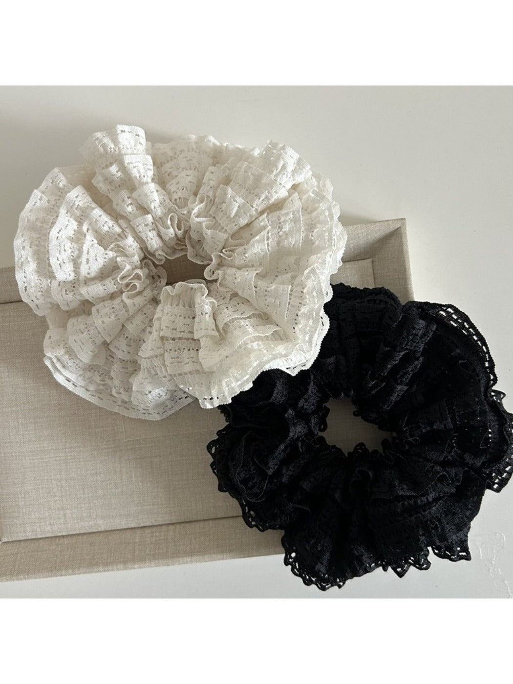 Gifty Sweet Cutout Lace Scrunchie worn on a wrist as a stylish accessory