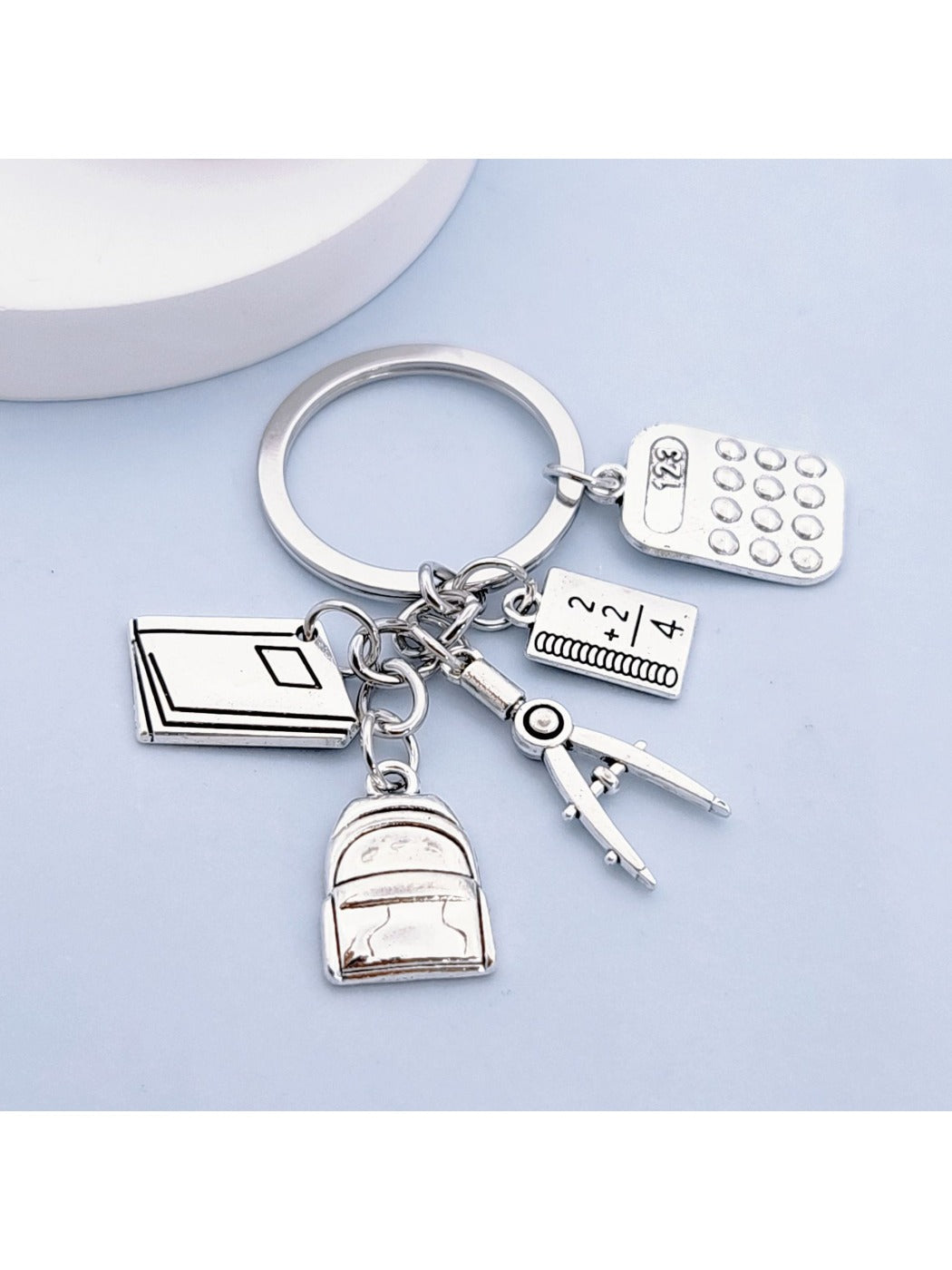 Side view of the alloy backpack book keychain highlighting the clasp