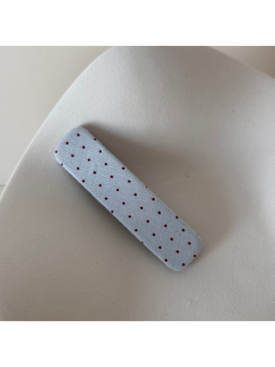 Beau hair clip displayed on a white surface highlighting polka dot pattern