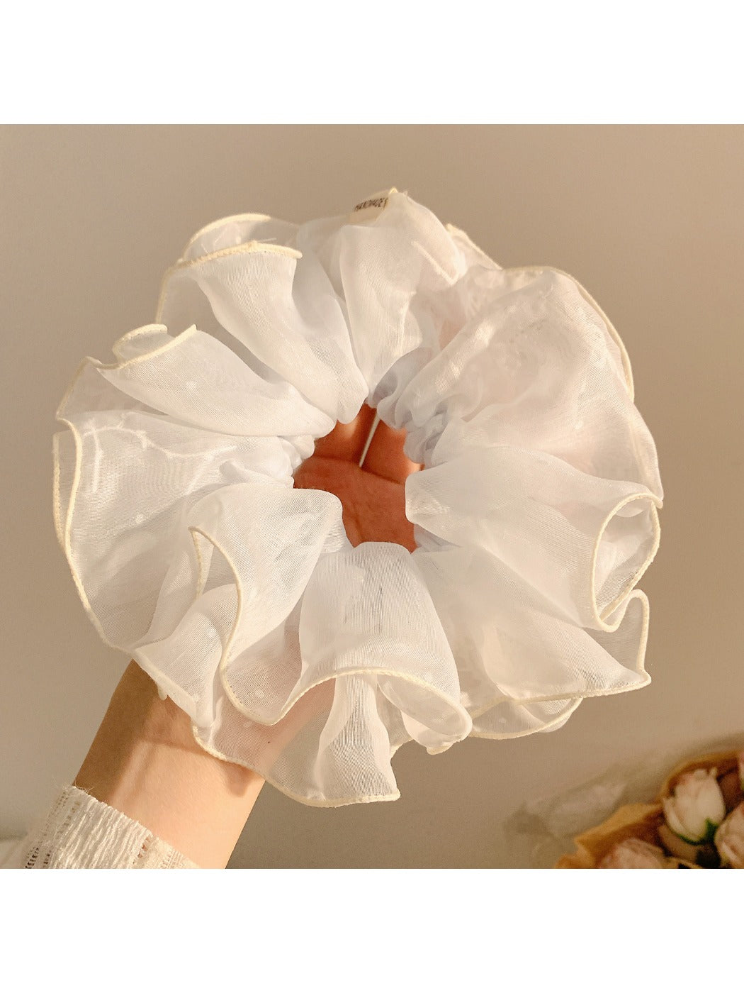 Model wearing double layer tulle scrunchie styled in loose hair bun