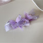 Elegant butterfly decorated banana clip photographed with soft lighting on a neutral background