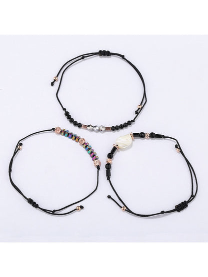 Lovra bracelet displayed flat showing detailed beadwork on woven black cord
