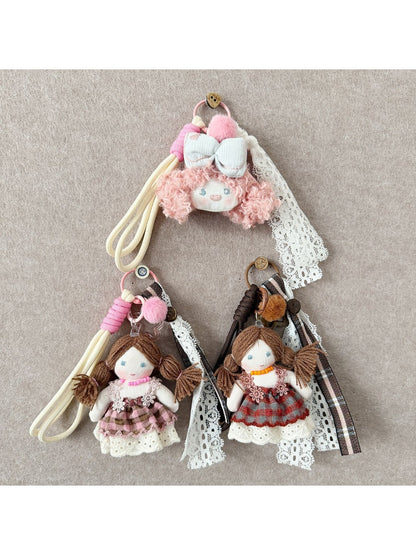 Front view of Keypus double ponytail fabric doll keychain with smiling face