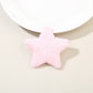 Side angle of plush star hair clip showing thickness and soft plush fabric