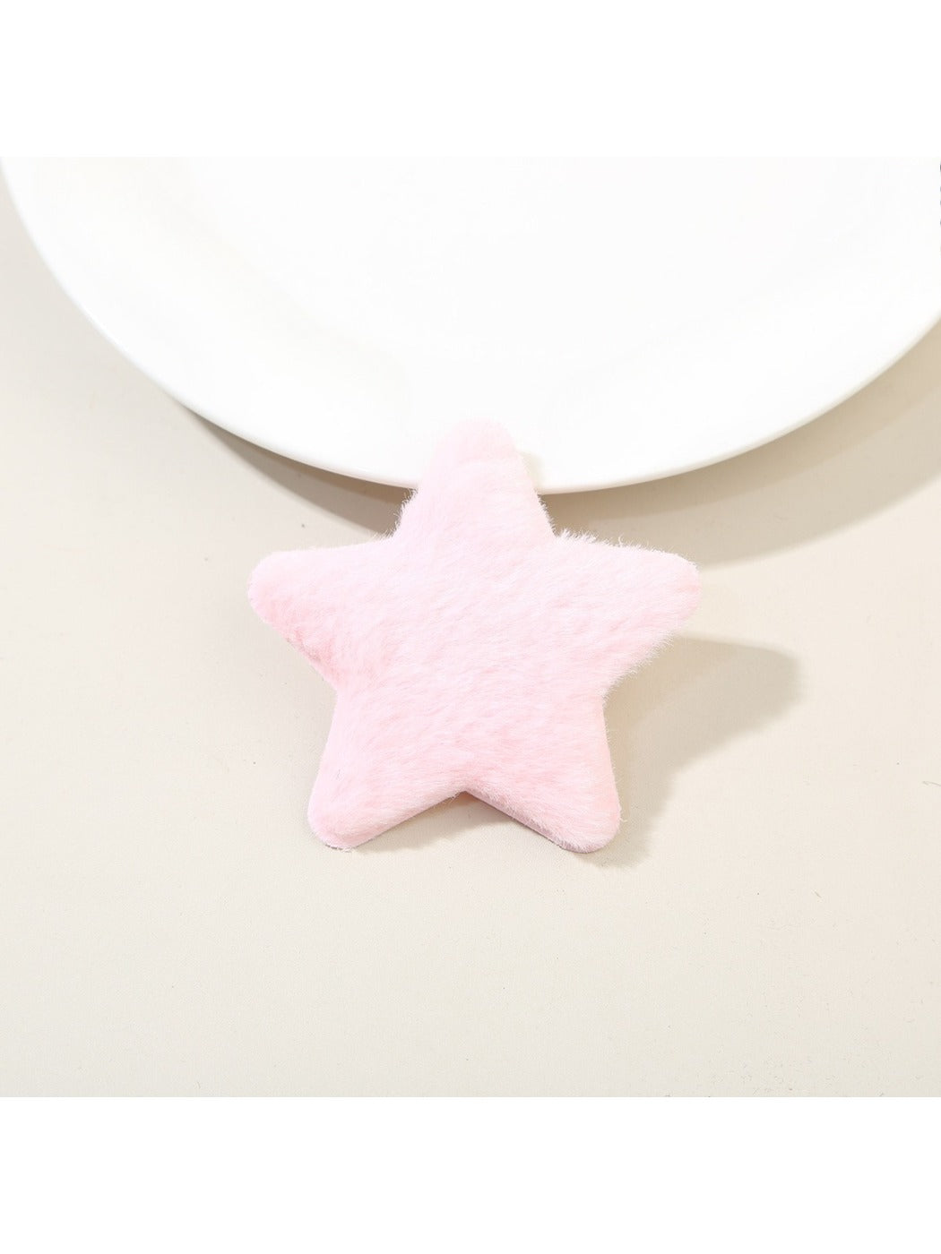 Side angle of plush star hair clip showing thickness and soft plush fabric