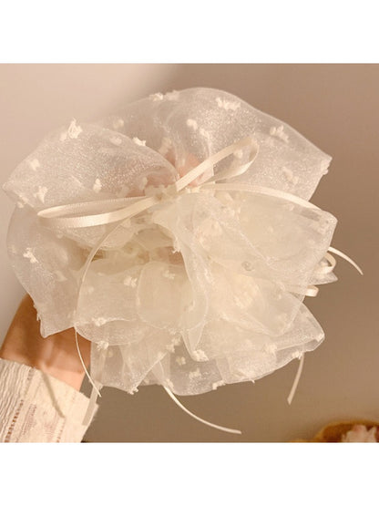 White double layer scrunchie laid flat highlighting its smooth fabric and layers