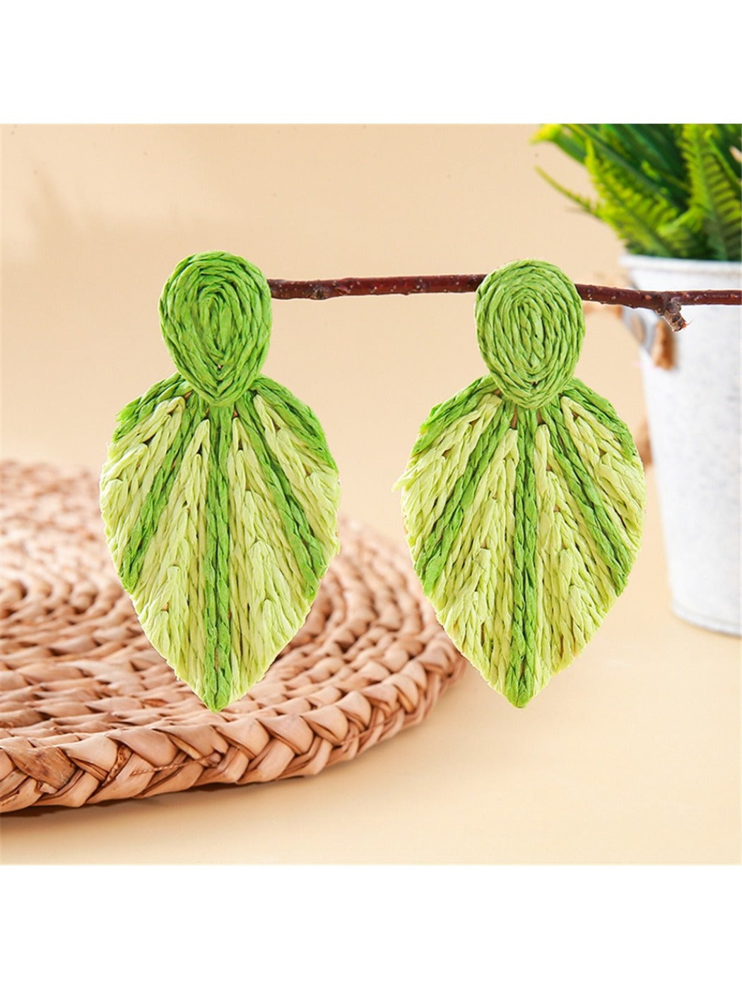 Detailed shot of the woven raffia pattern on Earedge leaf shaped earrings