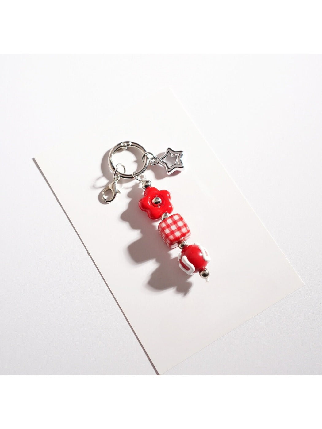 Keypus star-shaped keychain with vibrant beads shown from an angled perspective