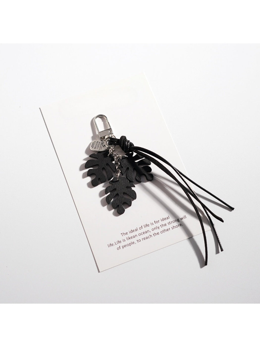Multiple Keypus leaf shaped keychains in different colors displayed on white background