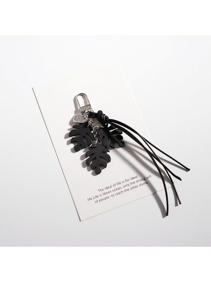 Multiple Keypus leaf shaped keychains in different colors displayed on white background