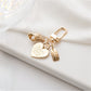 Alloy heart keychain hanging from a bag zipper pull