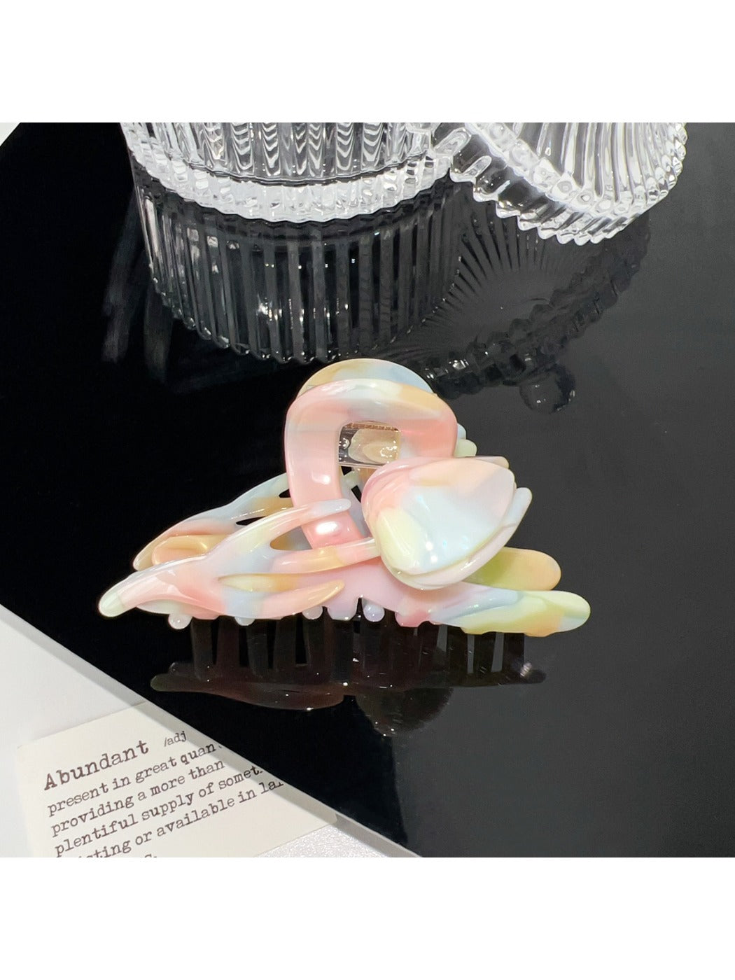 Beau colorful floral hair claw clip clipped in model's hair from side angle