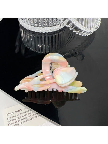 Beau colorful floral hair claw clip clipped in model's hair from side angle