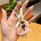 Rabbit charm keychain on a wooden table with natural light