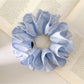 Blue double layer scrunchie held in hand showing texture