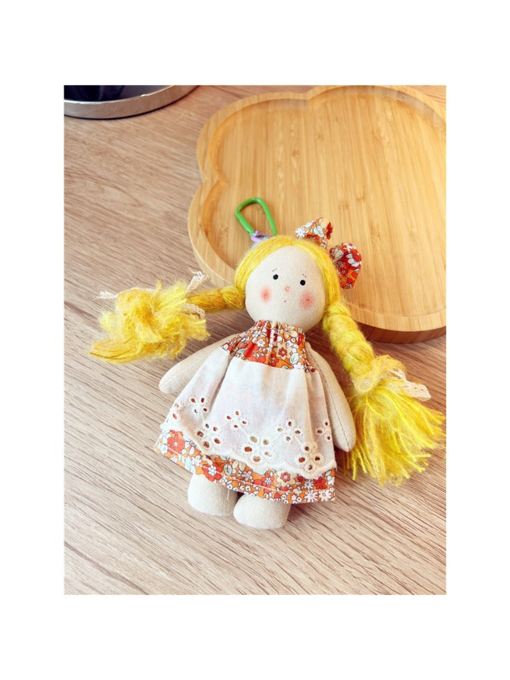 Keypus cartoon doll keychain attached to a set of keys on a key holder