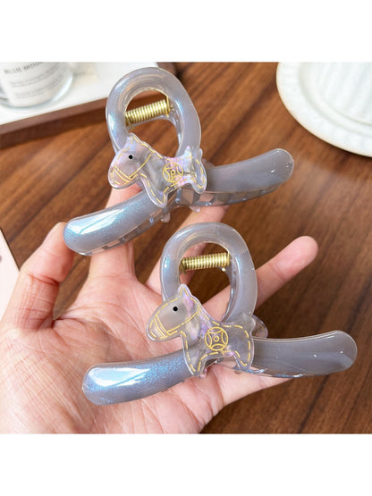 Close-up of Beau purple pony print claw clip showing curved teeth