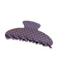 Beau hair clip styled in blonde hair with colorful polka dots visible