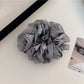 Flat lay of Gifty cut out ruched scrunchie on white background