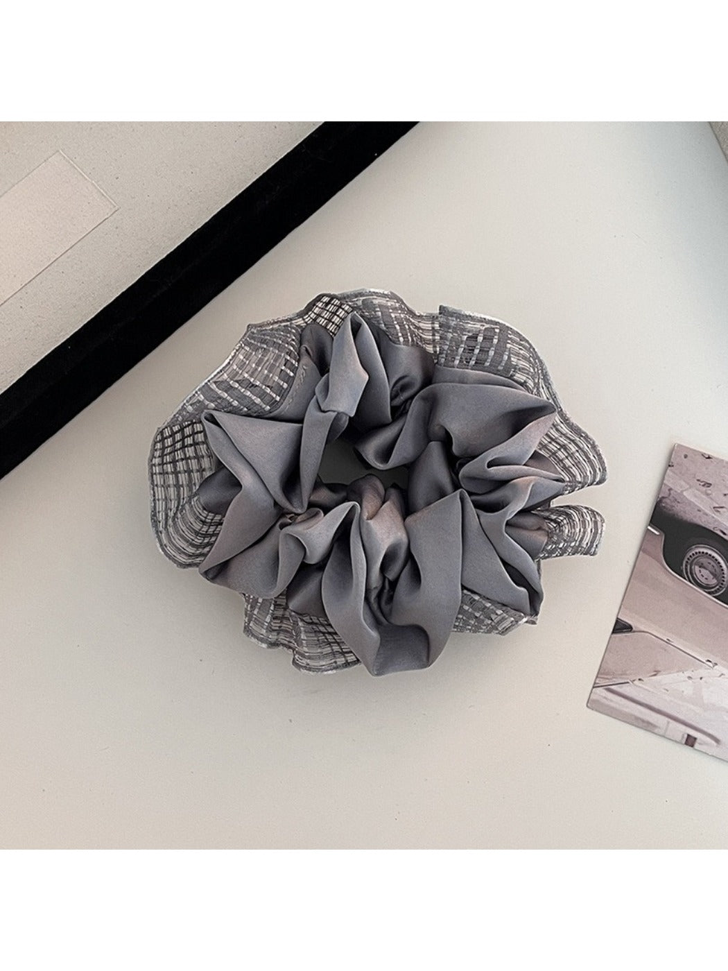 Flat lay of Gifty cut out ruched scrunchie on white background