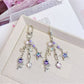 Close-up of purple star flower charm with detailed petals on keychain