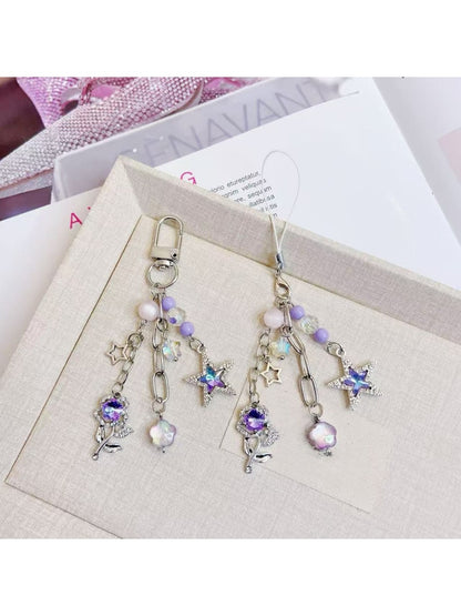 Close-up of purple star flower charm with detailed petals on keychain
