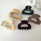 Side view of Beau vintage claw clip highlighting the semi circular form and claw teeth